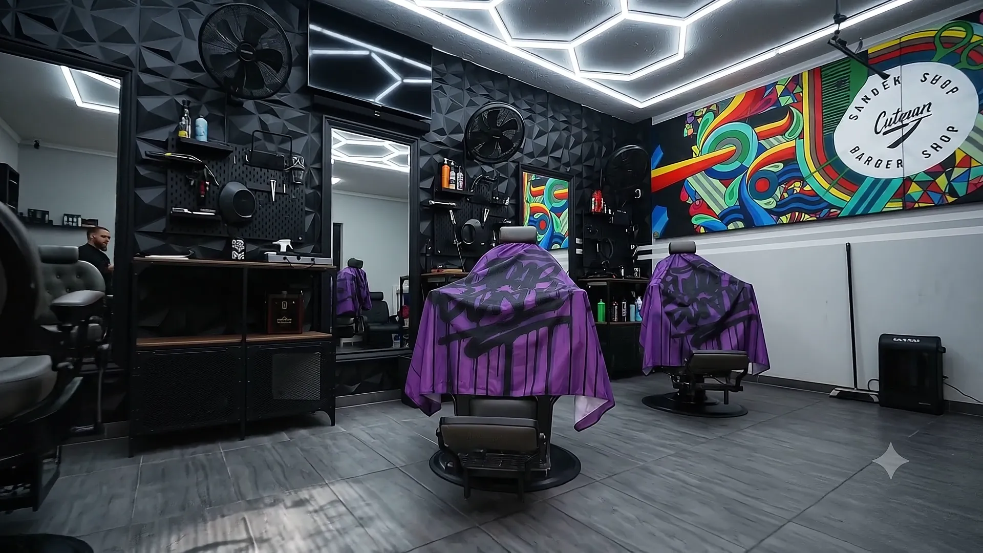 Barber chairs and the colorful Cutman mural inside our Klagenfurt shop